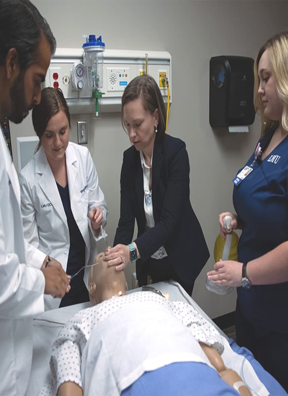students in hospital room with test patient