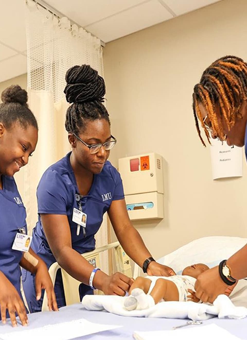 students taking care of baby