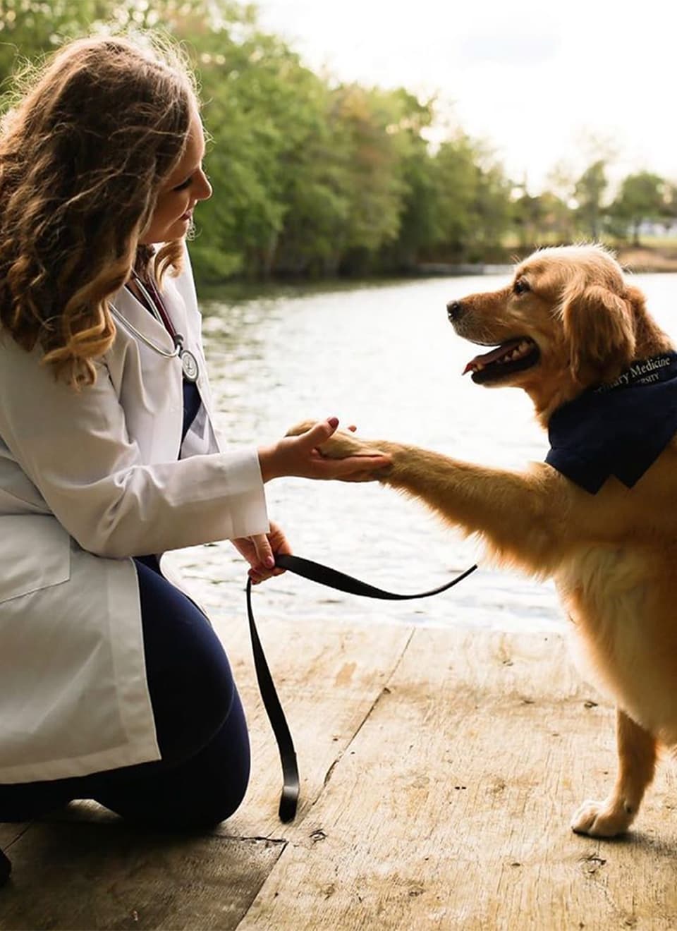 student checking dog