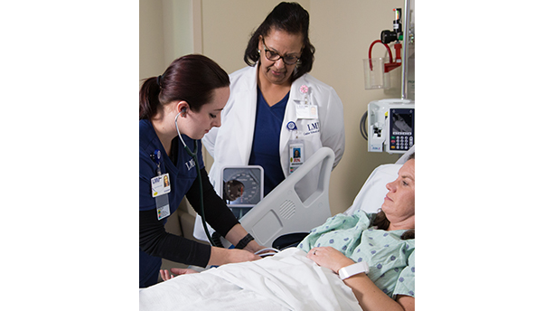 student and teacher with a patient