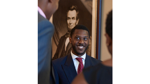 student in front of Lincoln portrait