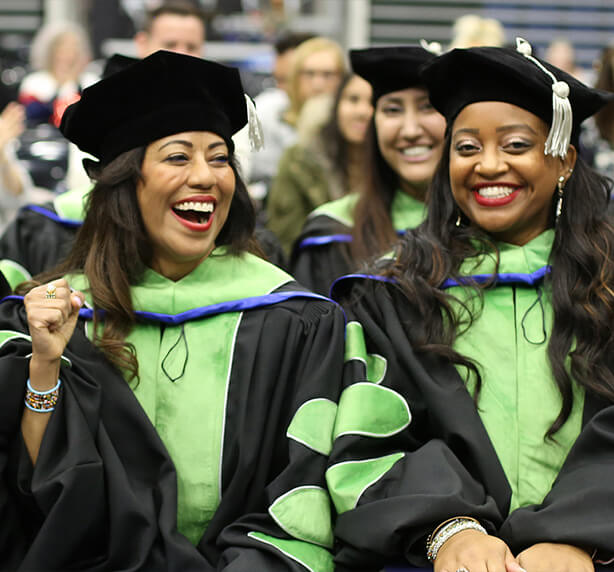 students smiling at graduation