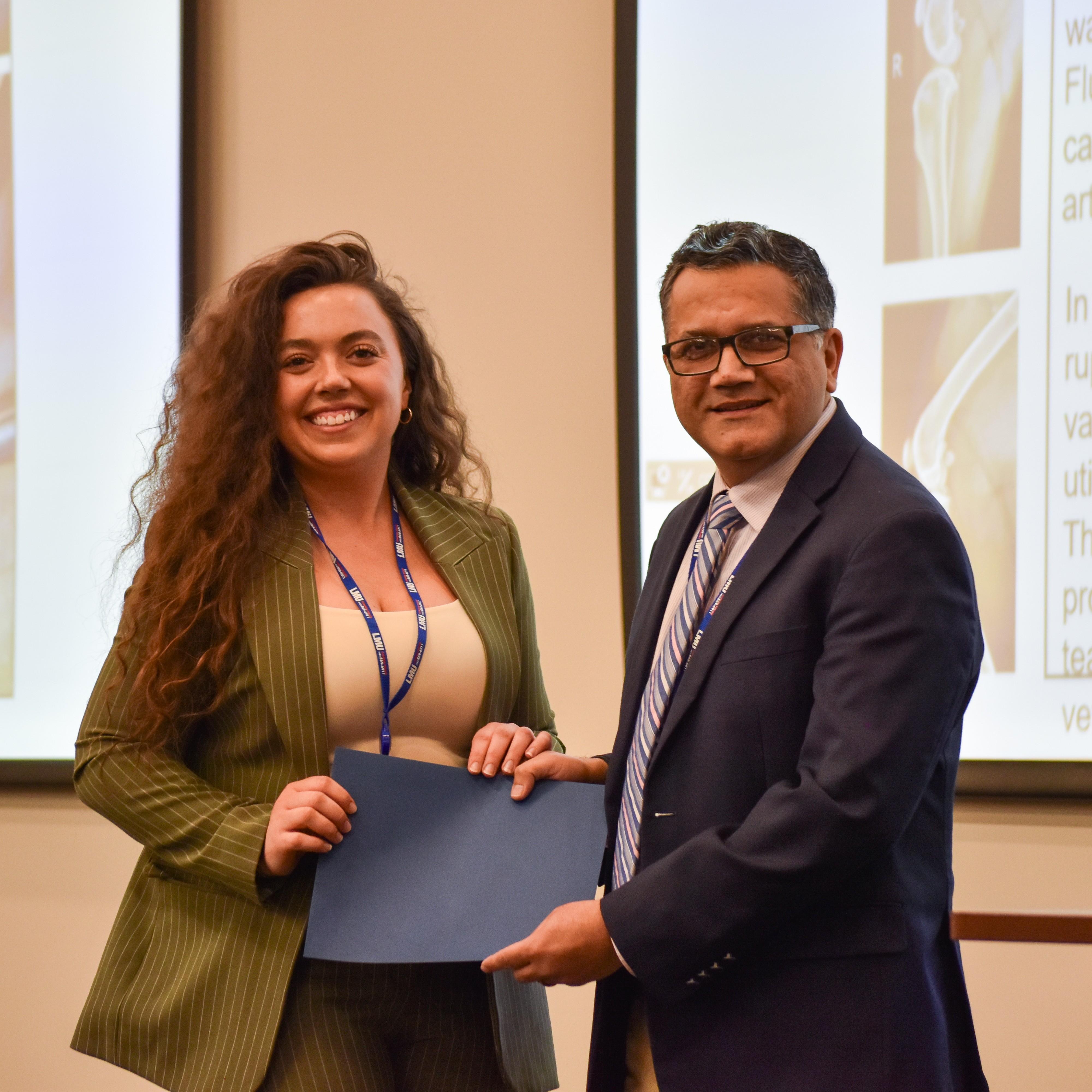 a student being presented an award from a faculty member