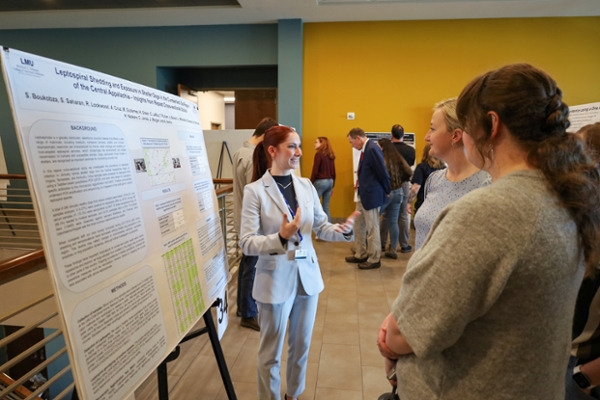 a student giving a poster presentation