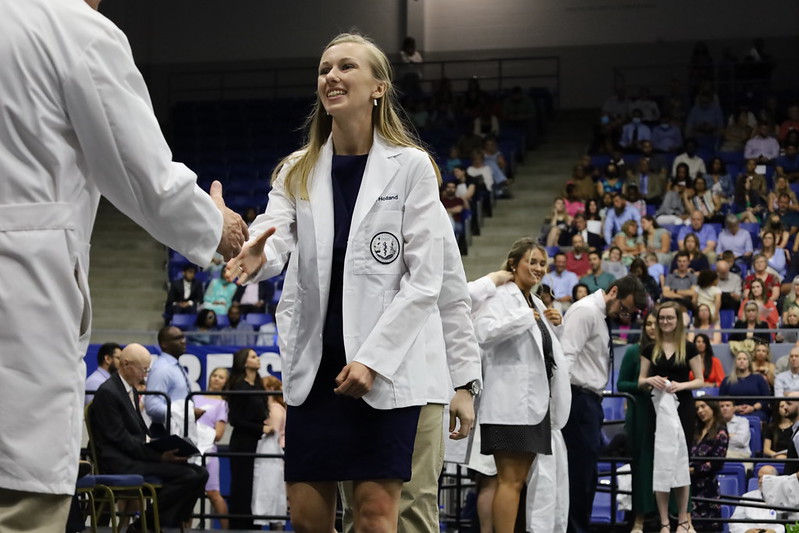 Student on stage shaking hands