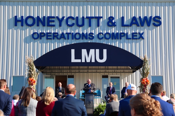 dedication ceremony with building in background