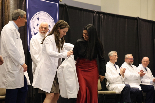 LMU-DCOM student receiving white coat