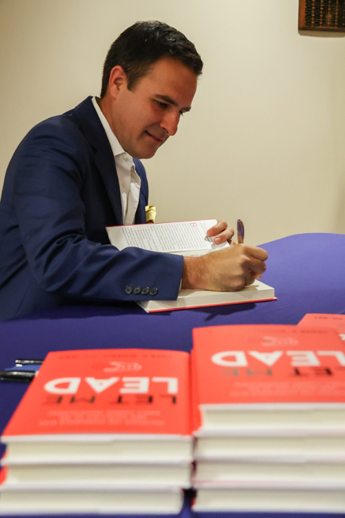 Dr. Seger Morris signing copies of his book