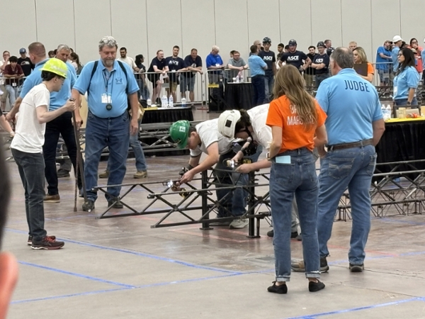 Engineering Students working with their steel bridge
