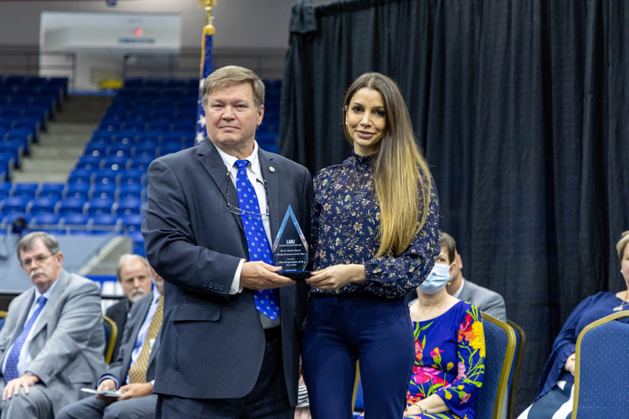 Dr. Hess presents Dr. Alin Gragossian with the Young Alumnus of the Year Award.