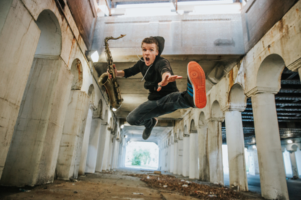 Man with saxophone jumping.