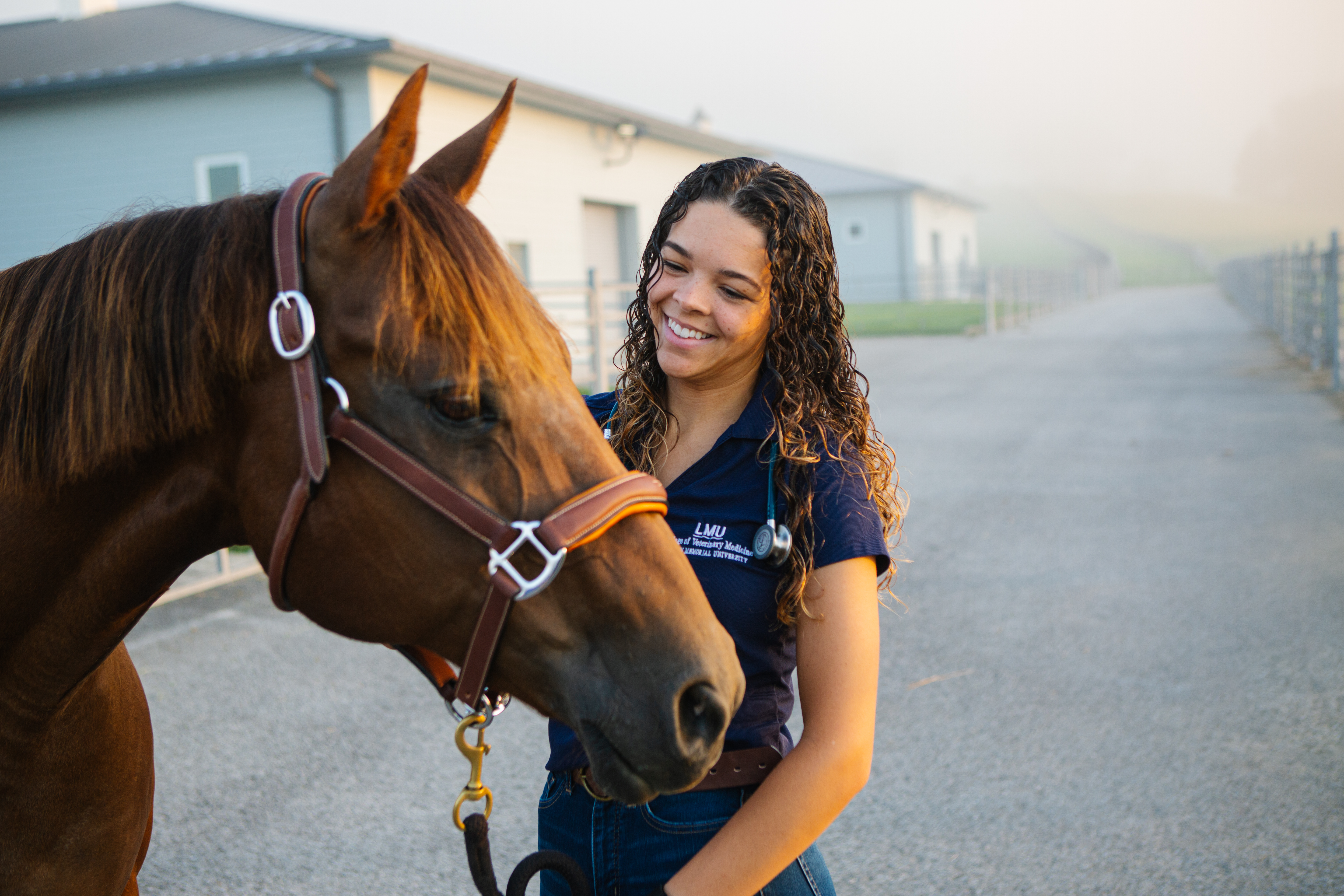 Student posing with a horse