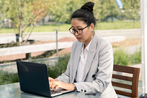 Female sitting in front of a laptop.