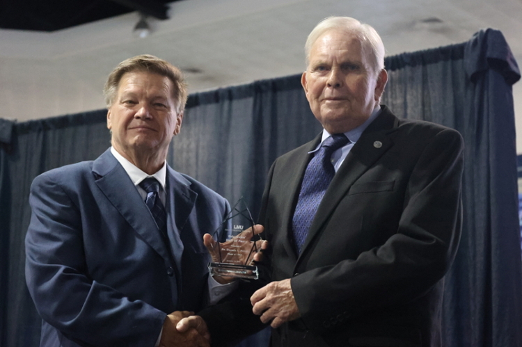 Dr. Clayton Hess, left, presents award to Dr. Denny Peters.