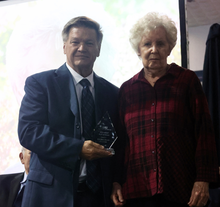 Dr. Clayton Hess, left, presents award to Etta Jane Norris.