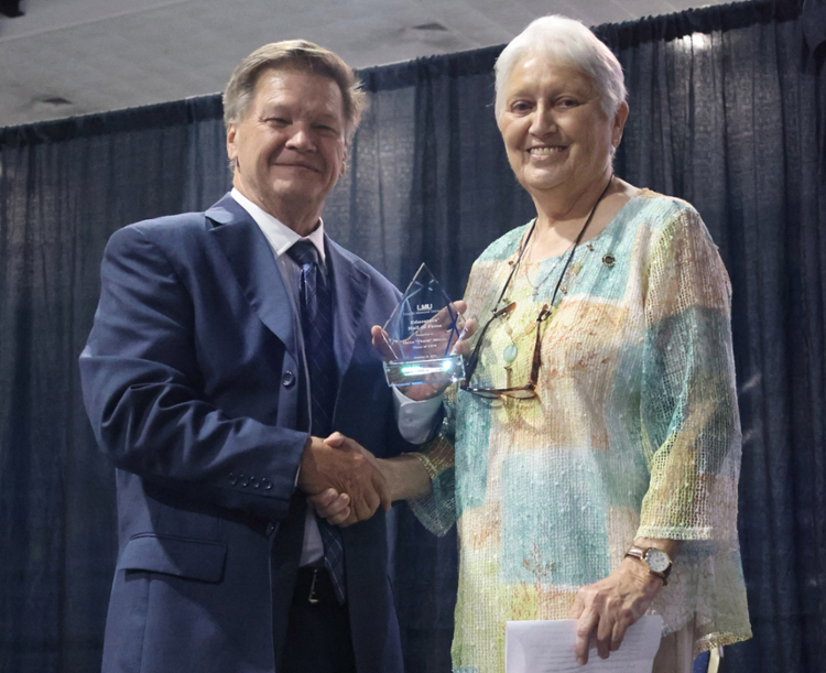 Dr. Clayton Hess, left, presents award to Elaine Minton.