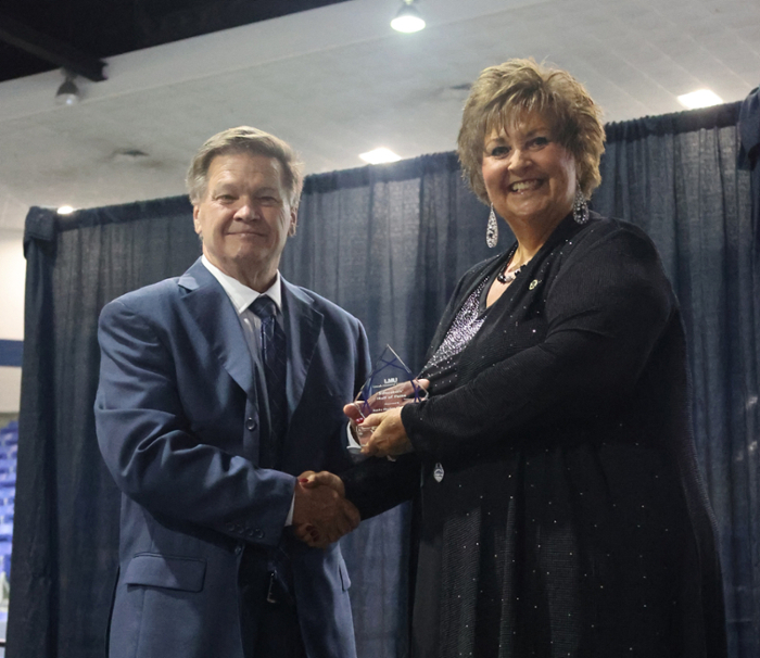 Dr. Clayton Hess, left, presents award to Katie Chumley.