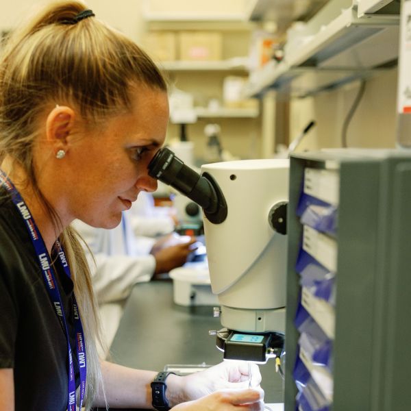 a student looking into a microscope