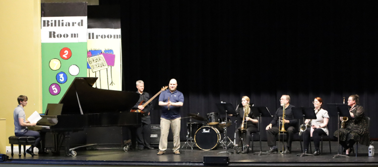 People with instruments on stage for a performance.