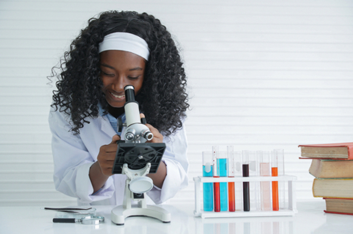 Student looking into microscope