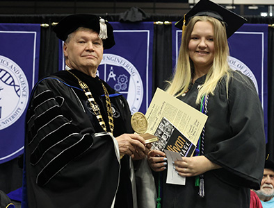 Dr. Hess presents award to Madison Criswell