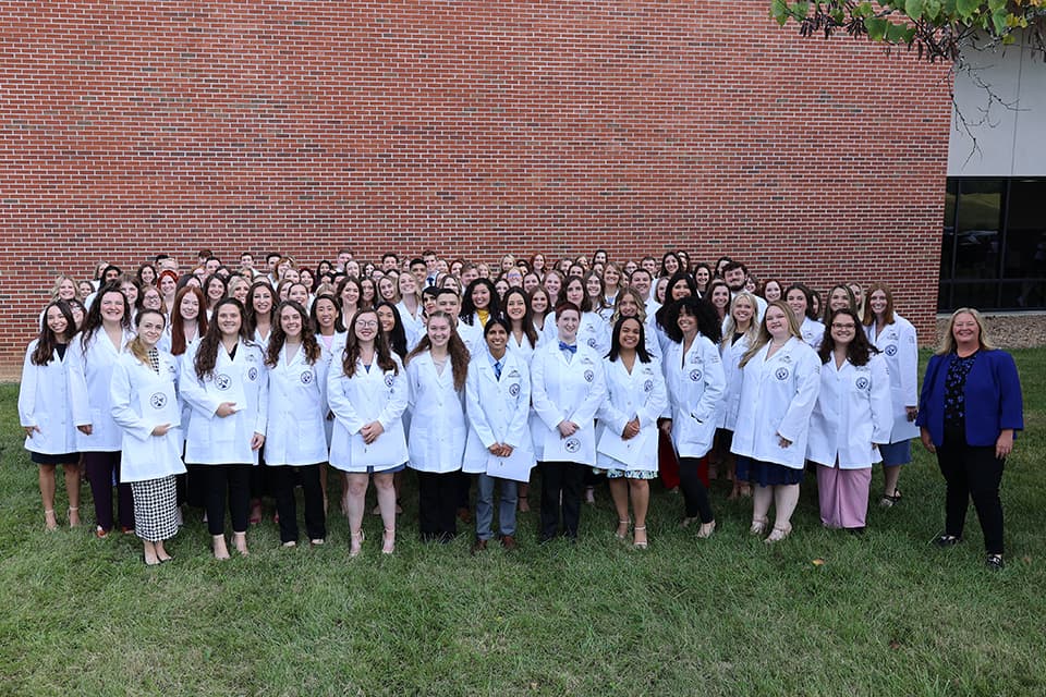 Blue Cohort group photo at white coat