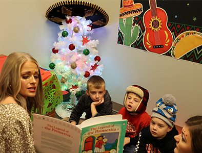 LMU Student reading to school kids