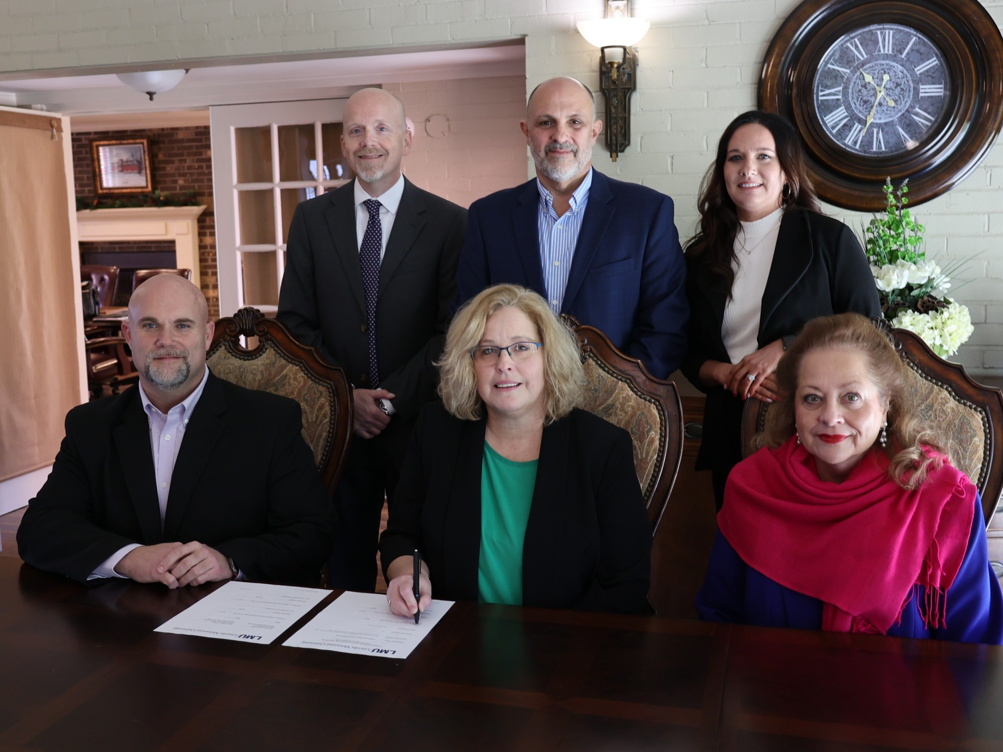 bank and LMU officials at the signing