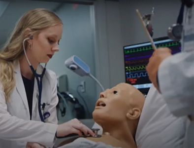 student interacting with simulation manikin 