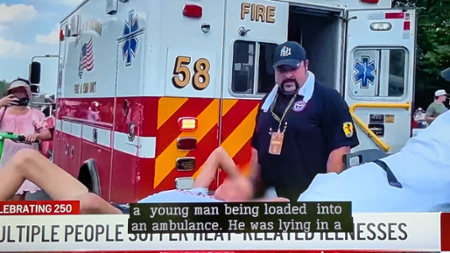 Dr. Michael Edwards helps load patient into ambulance