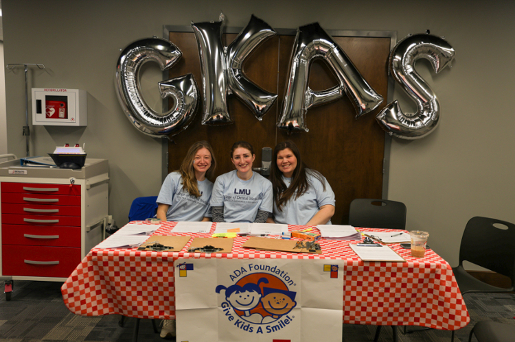 Students at a table for give kids a smile