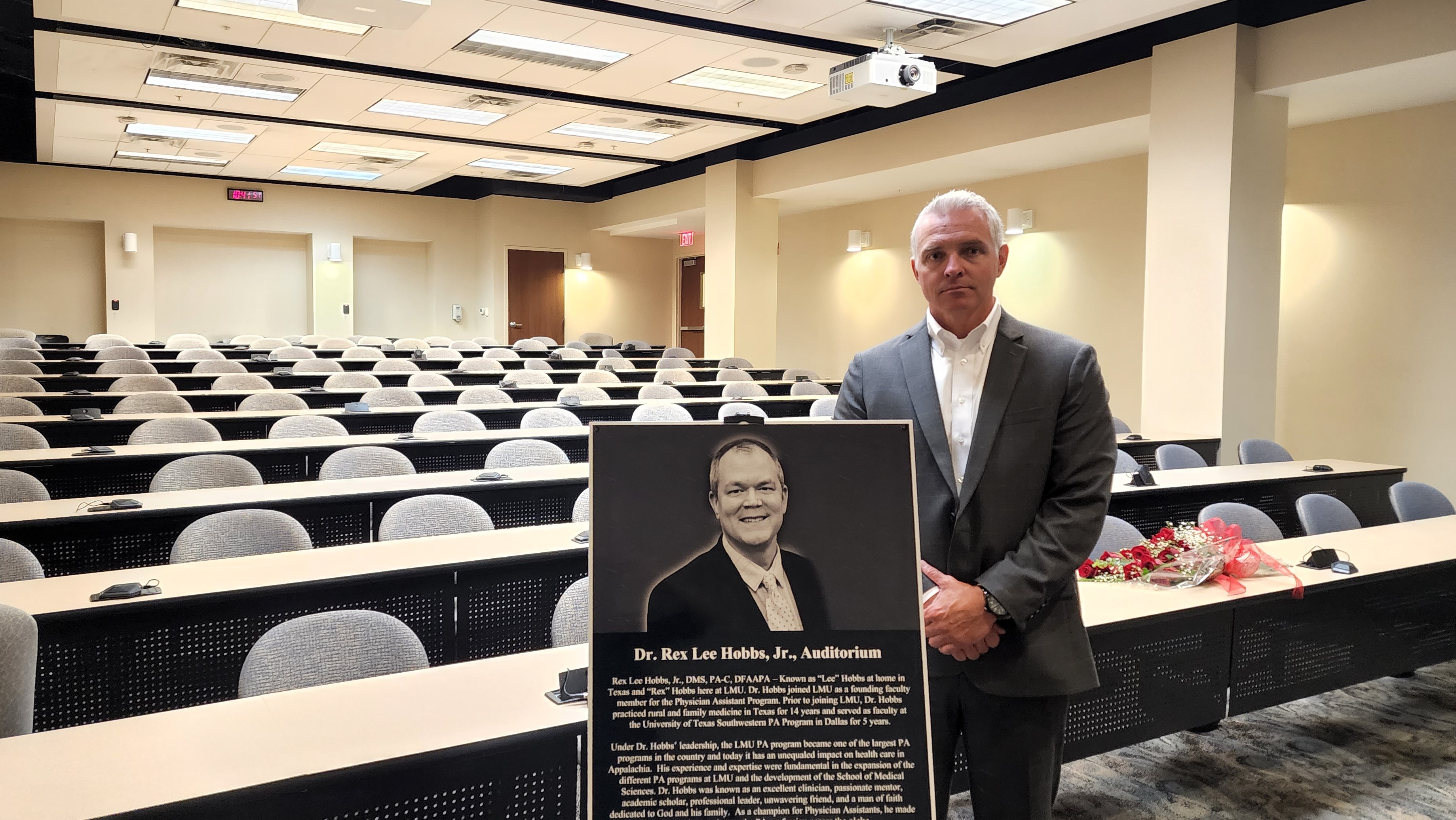 Dr. Stephens posing with plaque