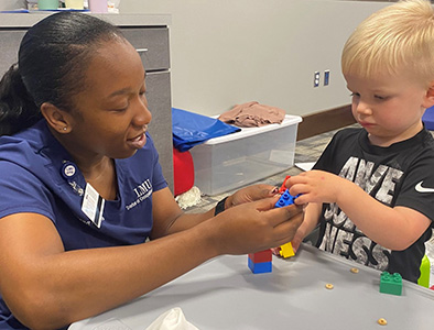 Occupational therapy student working with child