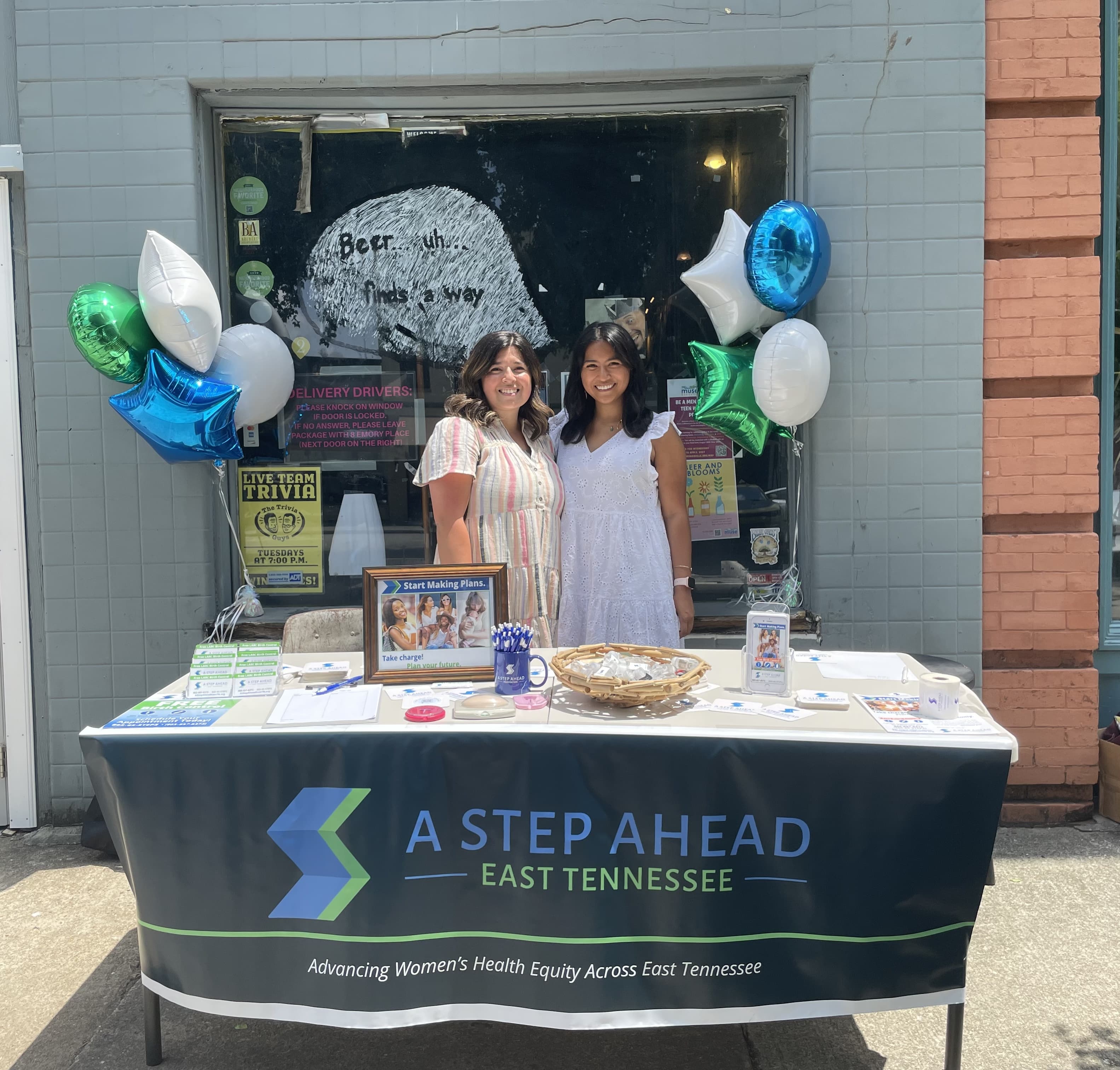 Sico and Taylor hosting an information booth