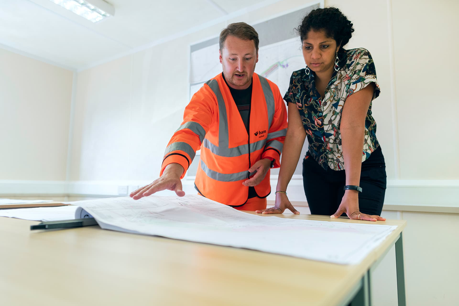 Engineers looking at a blueprint on a table