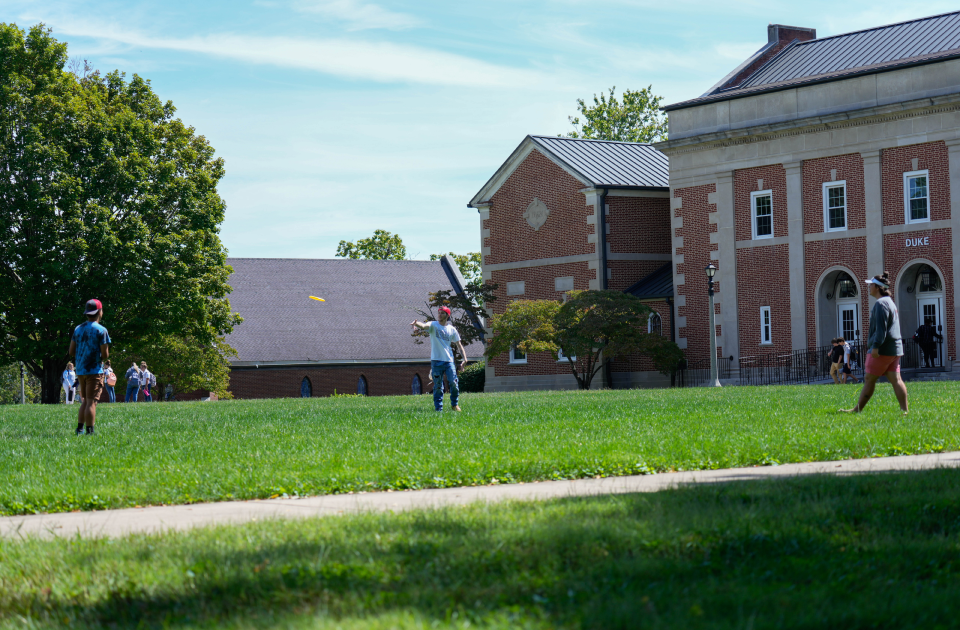 A group of students playing frisbee.