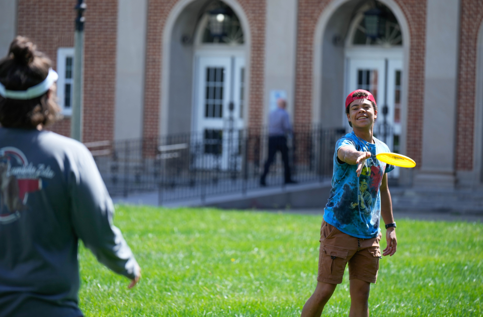 A group of students playing frisbee.