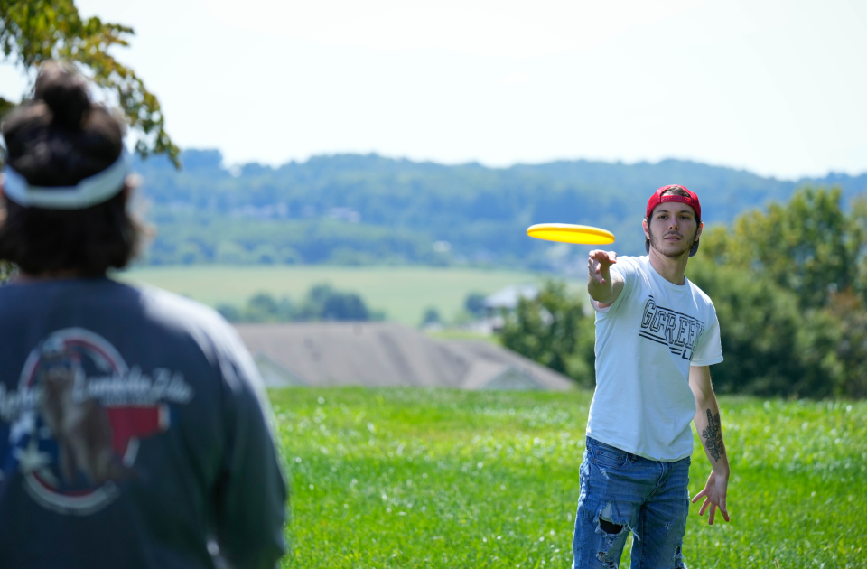 Students playing frisbee on the campus of LMU.