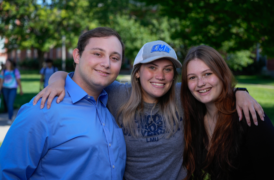 Three students smiling.